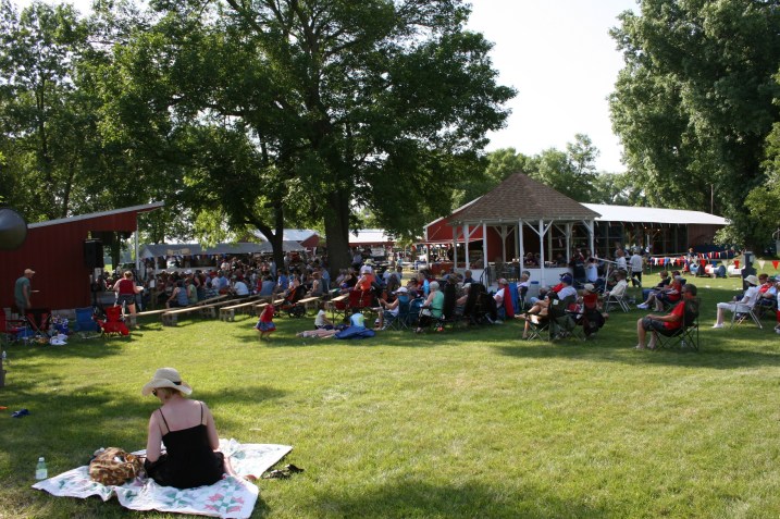 A large crowd enjoys a free afternoon concert by Monroe Crossing.