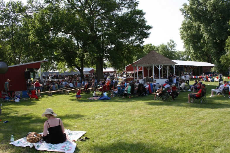 A large crowd enjoys a free afternoon concert by Monroe Crossing.