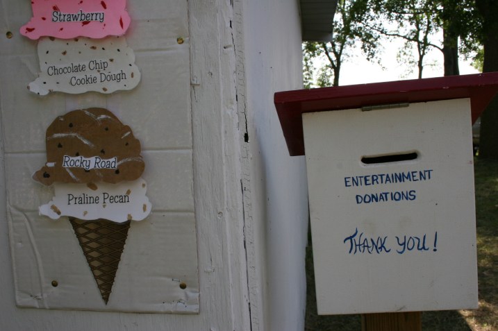 Visitors stopping by the ice cream shop can drop donations for the entertainment into a drop box.