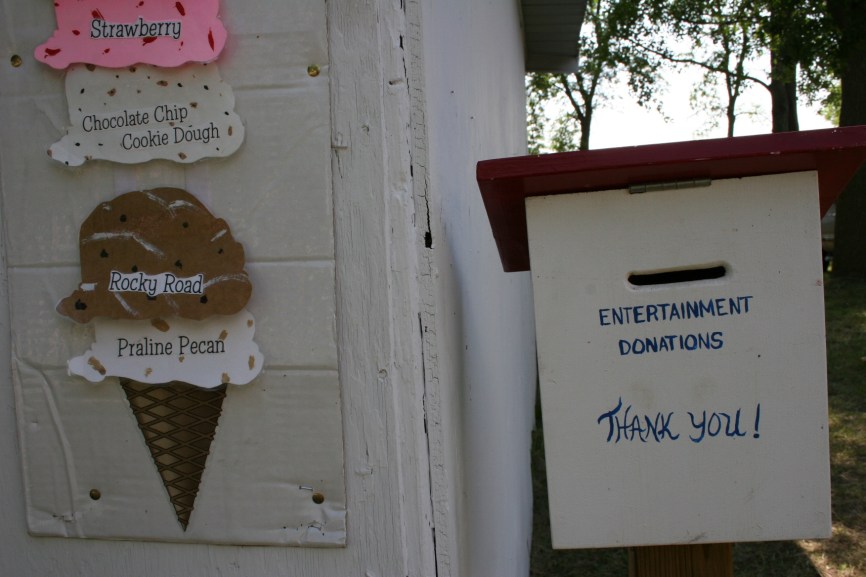 Visitors stopping by the ice cream shop can drop donations for the entertainment into a drop box.