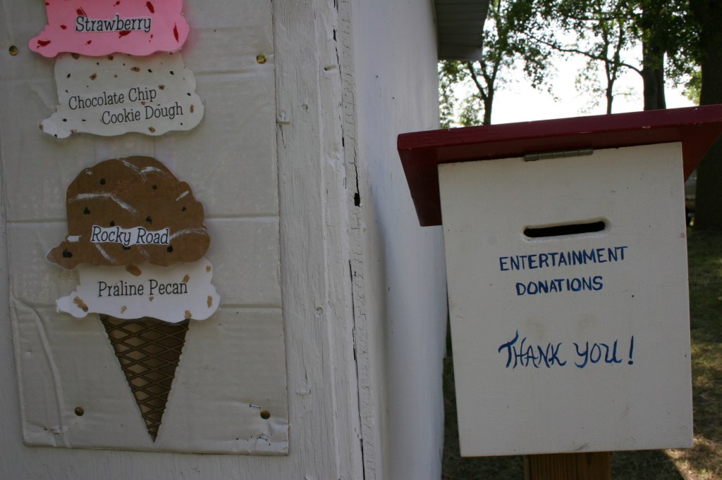 Visitors stopping by the ice cream shop can drop donations for the entertainment into a drop box.