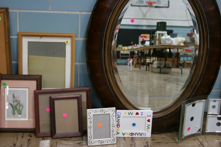 Frames and mirrors and merchandise reflected.