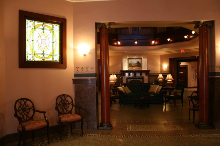 Moving toward the atrium, note the stained glass and pillars and original flooring.