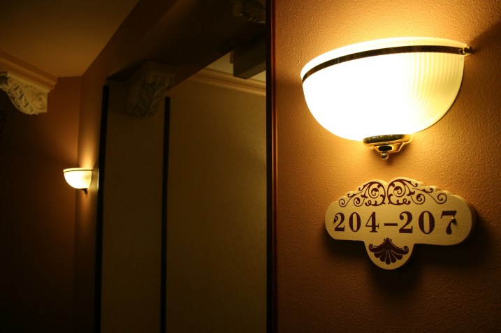 Even the sconces and room signage fit the historic mood.