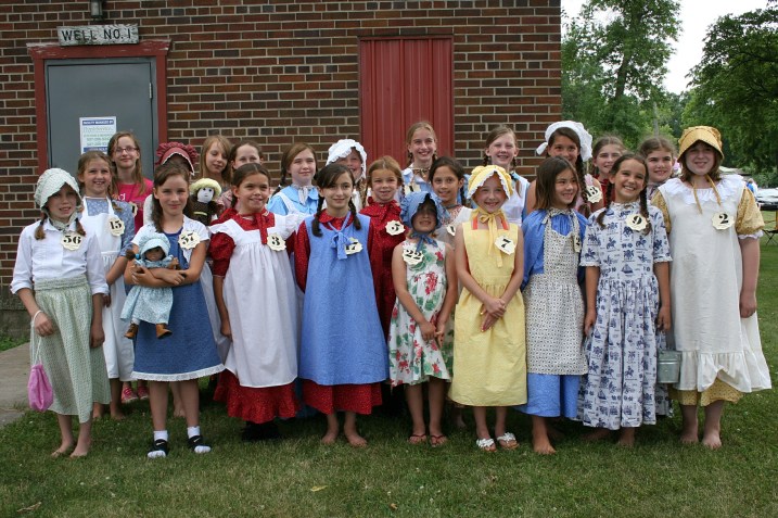 The Laura Look-A-Like contestants gather for a group shot in the park.