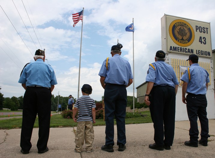 The Color Guard awaits the start of the ceremony as does Carter Quinlan, who later will receive an American flag honoring the Quinlan family.