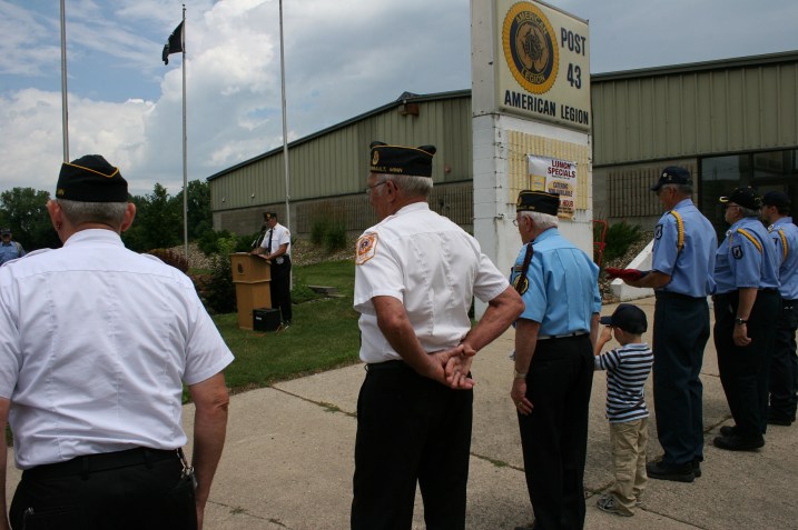 Carter Quinlan salutes in respect during the ceremony.