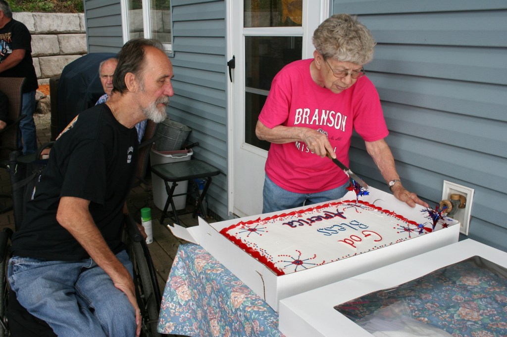 Geri Larson prepares to slice the cake, served along with sandwiches and beverages, after the dedication ceremony.