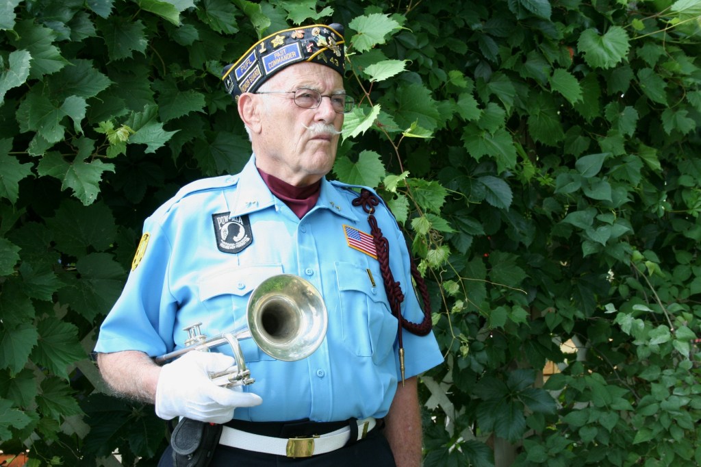 Lloyd Grandprey waits to play taps.