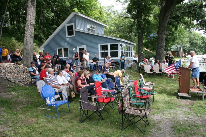 A portion of the crowd gathered for the ceremony. Attendees also lined a mulch-lined path along the steep side of the river bank to the read in this photo.