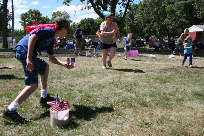 In the flag race, contestants carry flags from one ice cream bucket to another.