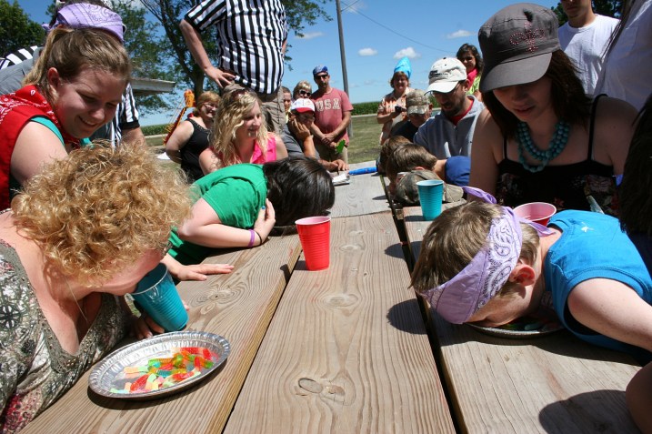 In this game, contestants race to move gummy worms from a pie plate into a cup, with their mouths. The plates were supposed to be filled with whipped cream, but someone left it in a hot vehicle and, well, there was no whipped cream. Perhaps just as well.
