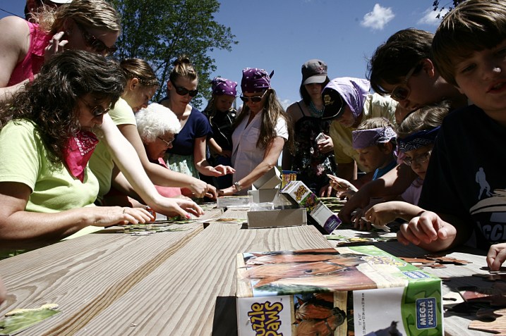 Teams work together in assembling 25-piece puzzles.
