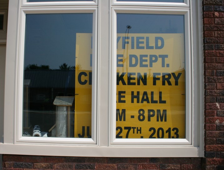 A sign in a window advertises the chicken dinner served during Hey Days.