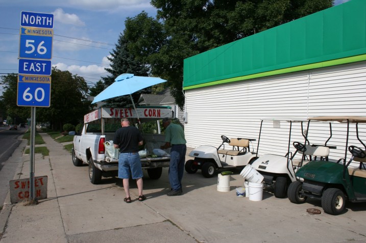 Bill Edelback sells sweetcorn, a green pepper, three cucumbers and a zucchini to my husband, Randy.