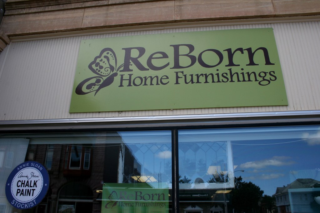 The butterfly on the signage symbolizes the rebirth aspect of transforming old home furnishings in to something new and unique.