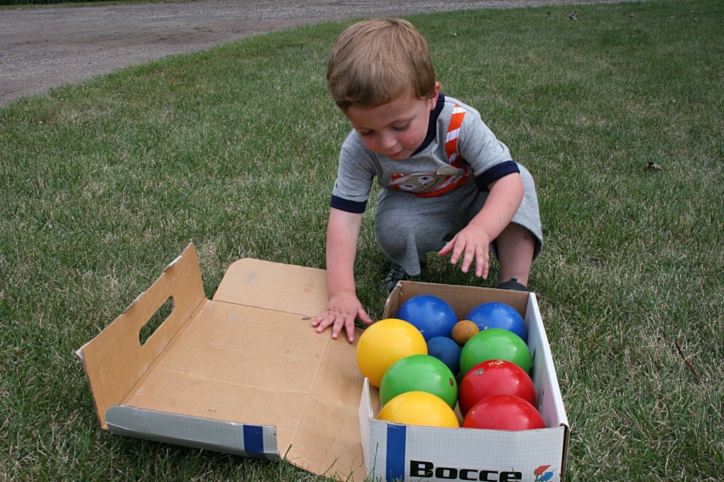 My great nephew Cameron eyes the bocce balls.