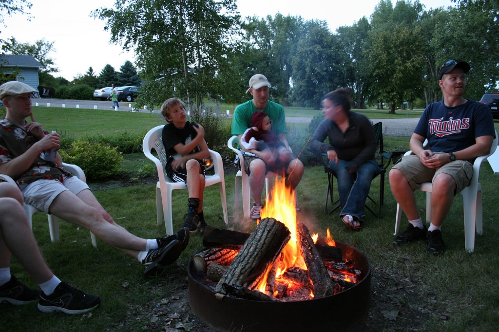 Laughter and conversation around the campfire.