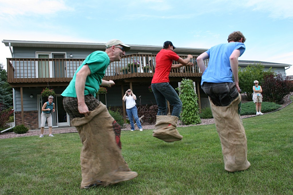 Cousins and a cousin-in-law going strong in the gunny sack race until...