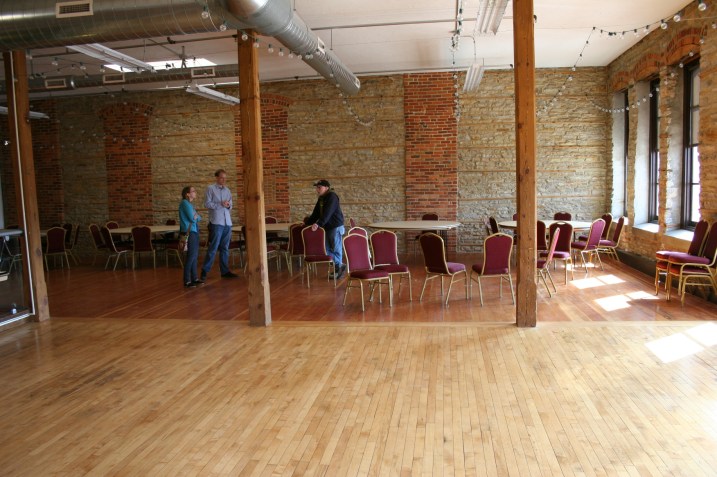 The couple looks at The Loft space with the bride's dad earlier this year.