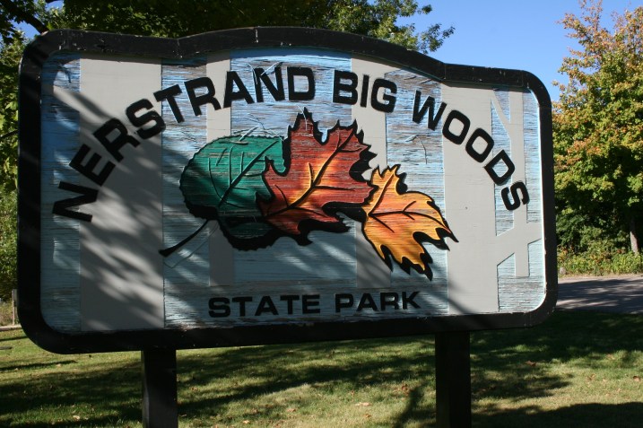 The sign welcoming visitors to Nerstrand Big Woods State Park, known for its beautiful fall colors.