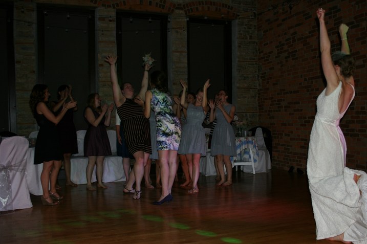 The single ladies celebrate after one of them catches the bouquet.