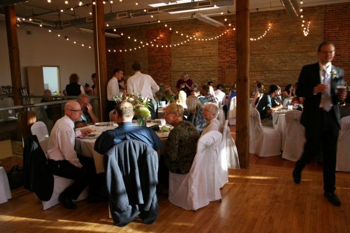 The groom walks past the bride's parents' table.