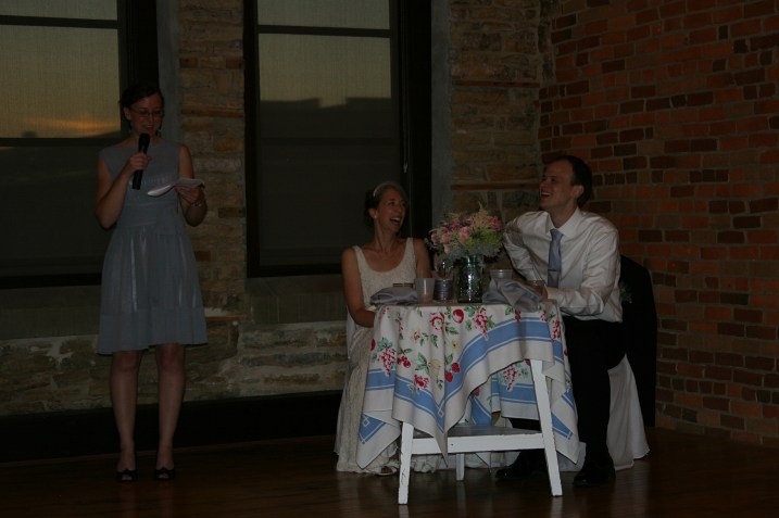 The bride's sister and maid of honor, Miranda, speaks and toasts the couple.