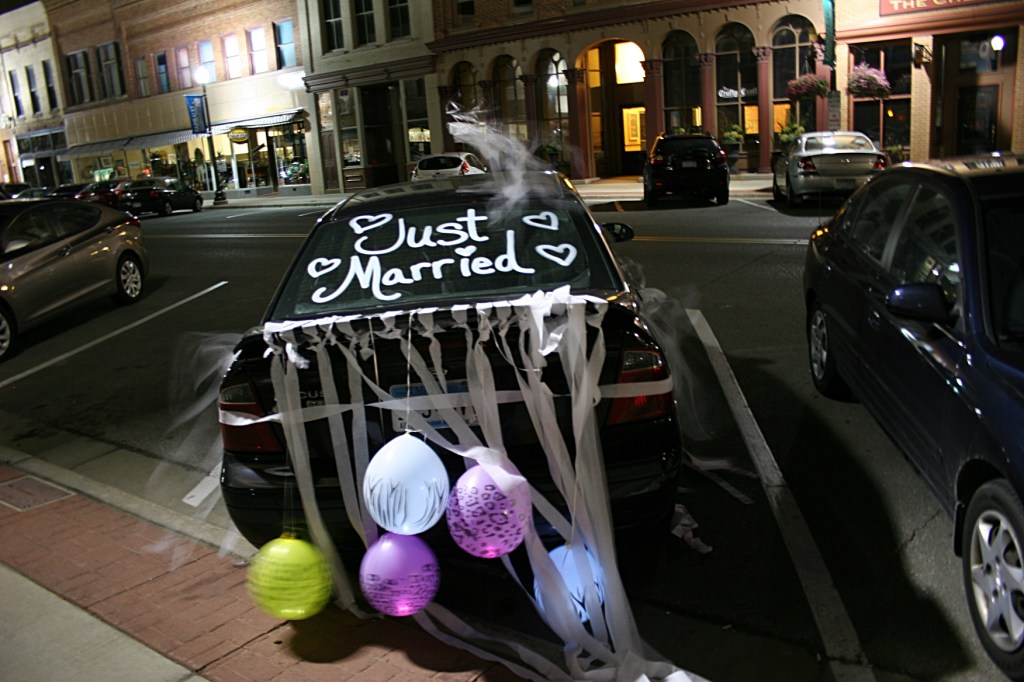 The couple's car, decorated and parked along Central Avenue in historic downtown Faribault, across the street from the reception venue, The Loft in the Bachrach Building.