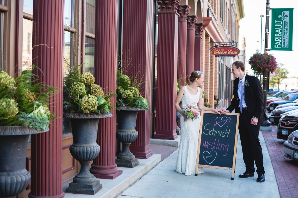 The couple arrives at the reception venue in the Bachrach Building in historic downtown Faribault. The social hour was held in the first floor Atrium and the reception in the second floor The Loft. The exterior floral pieces were created by my floral designer sister, Lanae Feser of Waseca Floral. Photo by and courtesy of Rochelle Louise Photography of Minneapolis.