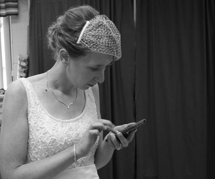 And back in the changing room, the bride uses her smart phone.