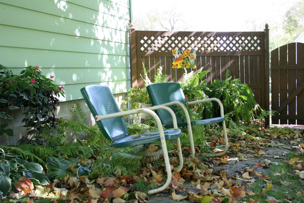 A favorite part of my backyard, vintage lawn chairs along a limestone pathway now covered with leaves.