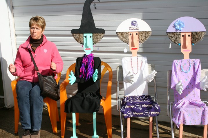 An empty chair provides a photo op for a shopper.