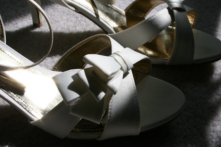 When Amber initially chose plain navy blue pumps to wear with her wedding gown, I had to zip my lips, sort of. They were her "something blue," but I thought the wrong choice. I said something like "just make sure they don't show in photos." Eventually she changed her mind and chose these lovely bow-detailed and classy shoes. She had her toenails painted blue for the "something blue."