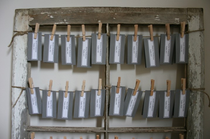 Name cards that the bride and groom created were attached to the old barn windows via jute and clothespins.