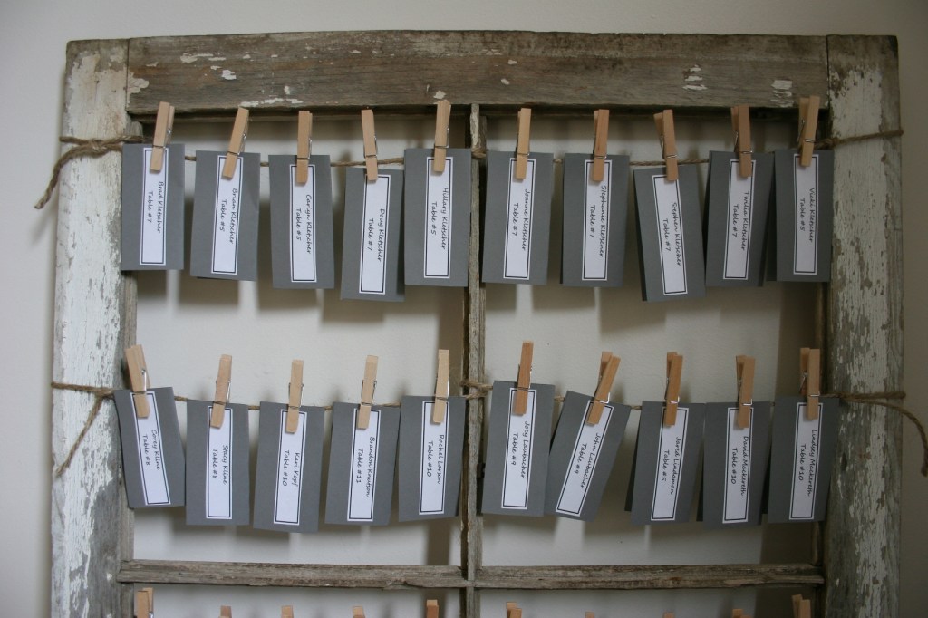 Name cards that the bride and groom created were attached to the old barn windows via jute and clothespins.