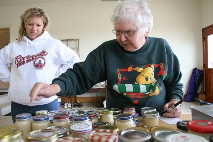 As the final step, The Supervisor steps in to count the jars. My sister-in-law, Vicki, watches my mom at work.