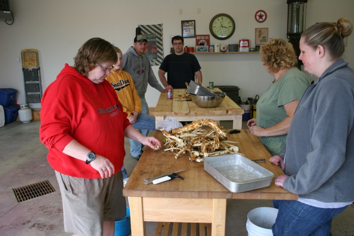 The crew (not all shown) prepares to peel the brown outer layer from the roots. Remove all of the brown so the end product is a creamy white.