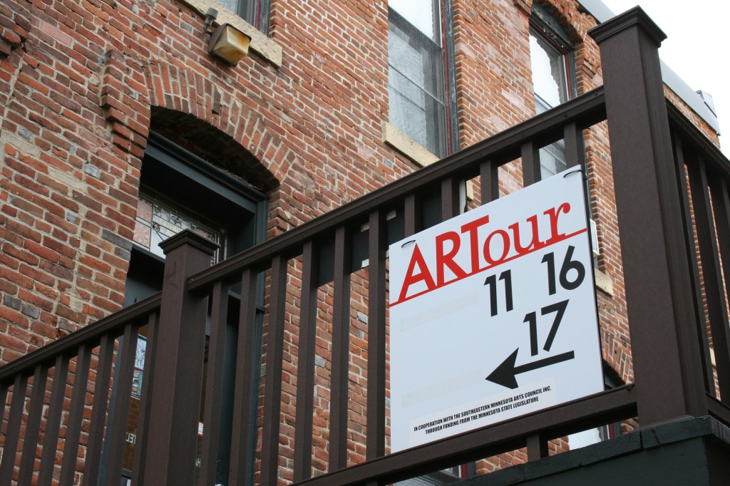 Signage directs visitors toward art studios on the third floor of an historic downtown Northfield building along East Fifth Street.