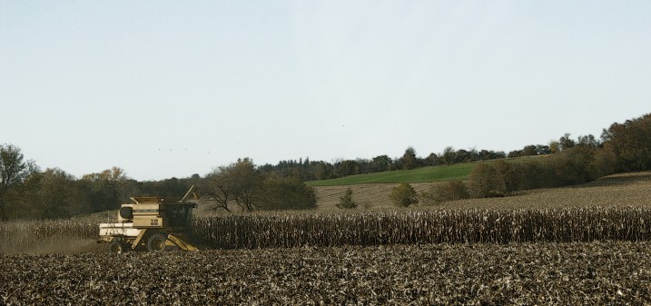 A combine works the land along U.S. Highway 52 north of Rochester.