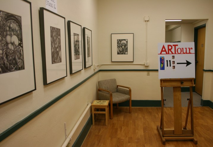 Maryrose's graphite drawings showcased in a hallway.