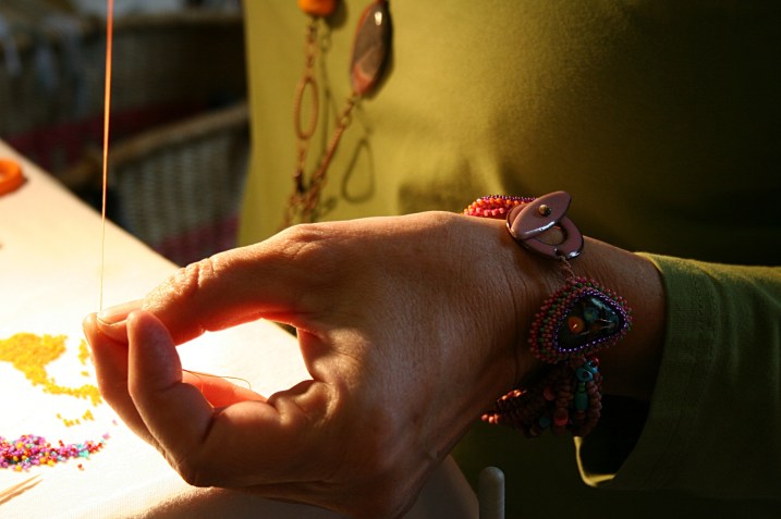 Artist Sue Hammes-Knopf of Full Bloom Beadworks at work beading.