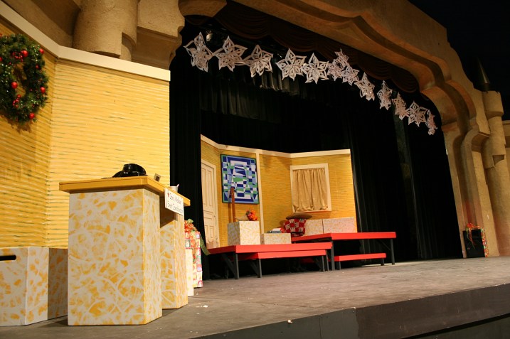 The sets are constantly changing in the performance. This set shows the Macy's Department Store desk of Doris Walker (Sydney Place-Sallstrom), left, and Doris and Susan Walker's apartment, center stage.