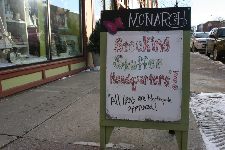 Detailed holiday signage draws shoppers into businesses.