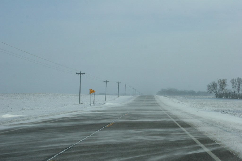 Strong winds drift snow across U.S. Highway 14 east of Lamberton this morning.