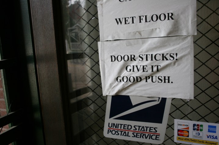 Garden City post office, sign on door