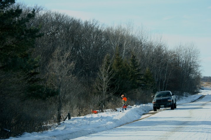 While some played, others worked. This guy prepares to saw wood along a rural roadway.