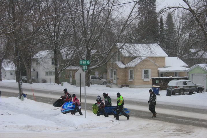 I photographed these winter enthusiasts heading up the hill to the park to go sledding.