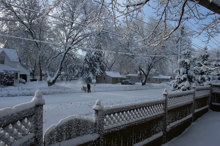 From my fenced backyard, I photographed my neighbor, Bob, blowing snow this morning.