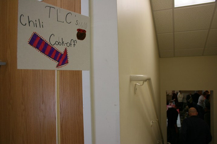 A sign directs diners to the church basement.